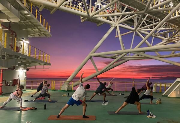 eBook author Paul Stokes teaching a yoga-based Stretch & Strength group fitness class on an Offshore gas facility in the Indian Ocean
